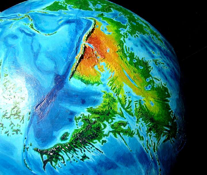 High orbital photo of Agassiz, a triangular southern continent on Abyssia, an alternate Earth whose relief has been inverted: heights are depths and vice versa.