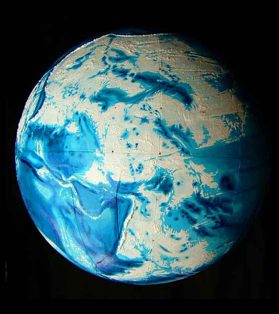 Relief globe of Abyssia, an Earth where up is down and down is up. Pacific hemisphere. Land is white, oceans blue (notably the Australian Deep in the lower left). Click to enlarge.