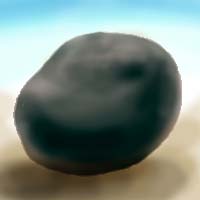A black stone egg on pale earth