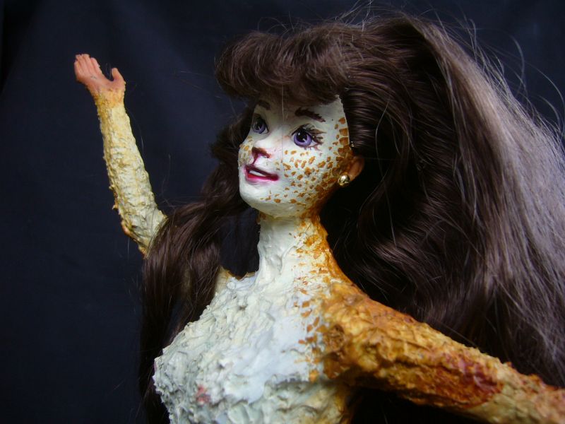 Barbie sculpture illustrating a dream by Chris Wayan: a gracile centauroid dancer, Lia. Closeup of smiling freckled face.