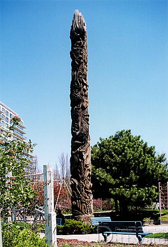 A dream-inspired totem pole on the Toronto waterfont by Georganna Malloff, showing people and whales.