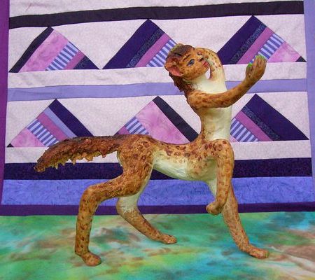 Leopardlike centaur on stage; backdrop stylizes the Mariana Mountains, on Inversia, where land is sea & sea land.