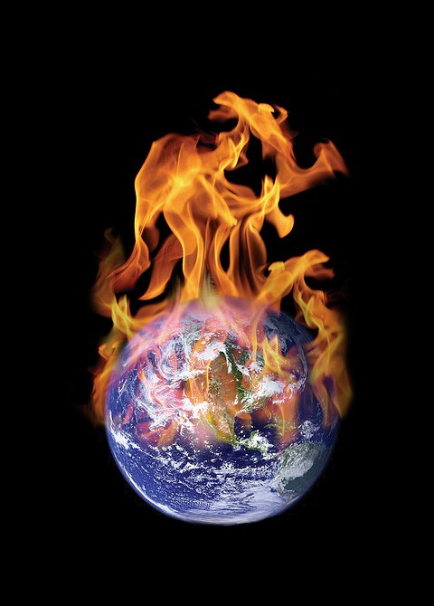 Photo of Earth with flames rising from its northern hemisphere.
