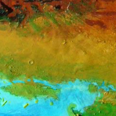 Orbital photo of an impact crater on the south coast of Iba, a continent on Kakalea, an unlucky Earthlike world: blue seas, red dry continents.