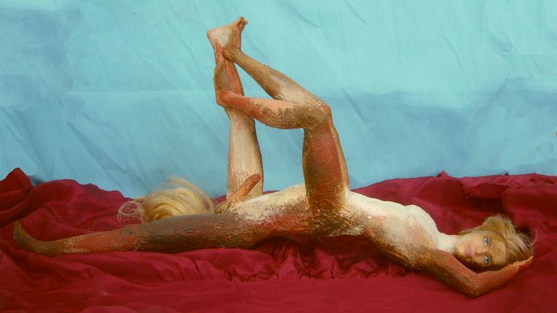Sculpture of glued Ken dolls by Wayan, titled 'Kentaur': a centauroid dancer supine in a red desert on Kakalea, a model of an Earthlike world full of Australias. Click to enlarge.