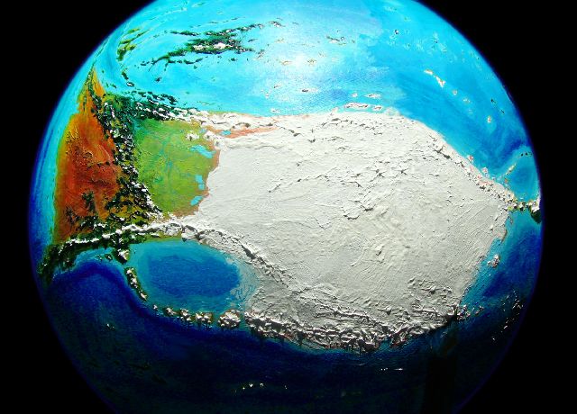 Orbital shot of the huge bone-shaped continent of Kita-Homa (Kita's arctic icecap on right, tundras and deserts of Homa on left); on Kakalea, a model of an Earthlike world full of Australias.