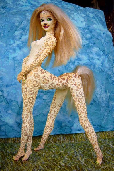 Sculpture of glued Barbies titled 'Shya': a gracile, cloud-leopard-pelted centauroid dancer on Kakalea, a model of an Earthlike world full of Australias. Click to enlarge