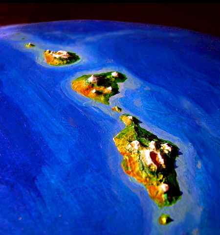 Low orbital photo near sunset of Eyath, Arinnian and Hrill, three volcanic deep-sea islands like oversized Hawaiis, on Lyr, a world-building experiment. Click to enlarge.