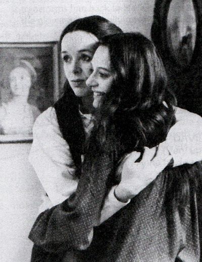 Sisters hugging, one smiling one sad; still from 'Sisters, or the Balance of Happiness' (1979) by Margarethe Von Trotta.