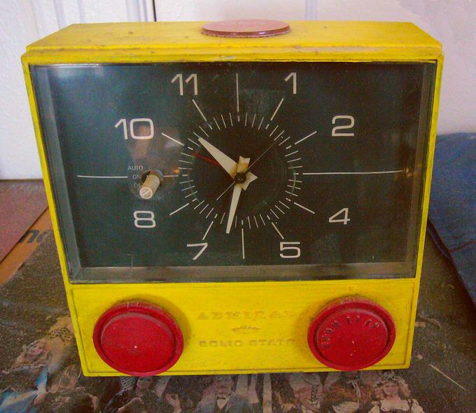 Midcentury clock-radio, hand-painted yellow with red dials. Click to enlarge.
