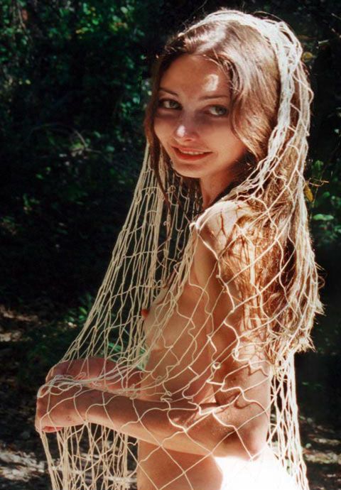 Girl draped only in fishnet.