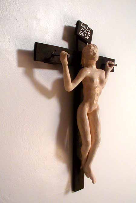 Girl on a cross that says RAISE YOURSELF--left view. Sculpture by Wayan.