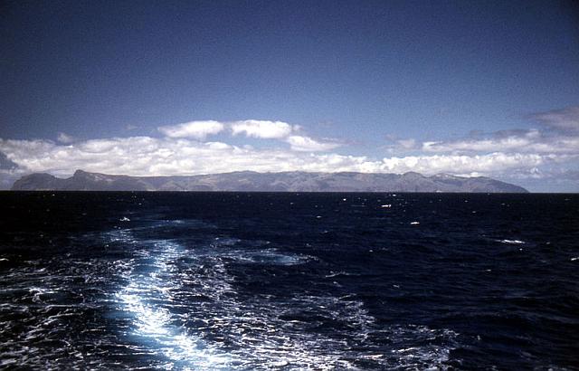 Photo of the rugged coast of St. Helena in the South Atlantic, from offshore. Wikipedia image.