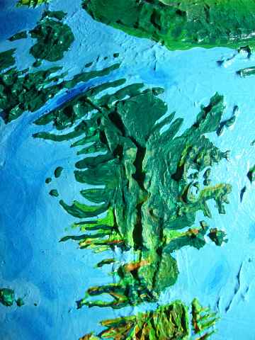 Orbital photo of a green, mountainous subcontinent: Helenia, the exposed highlands of the southern Mid-Atlantic Rift, on Siphonia, a study of the Earth with 90% of its water drained away.