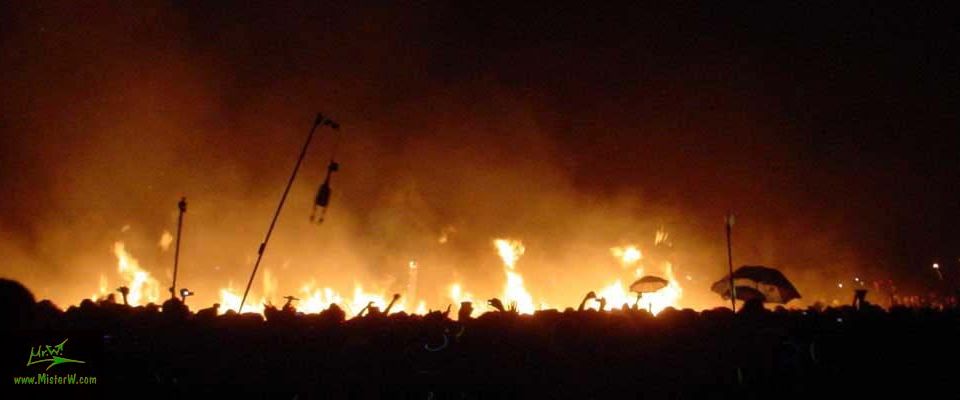 2004 Burning Man; dancers round the afterfire.