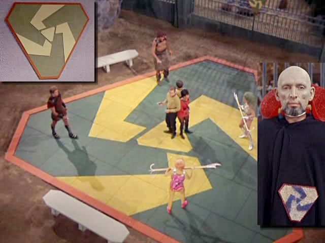 Still from an old Star Trek show, 'The Gamesters of Triskelion': a gladiatorial arena with inlaid three-armed spiral in gold and gray.