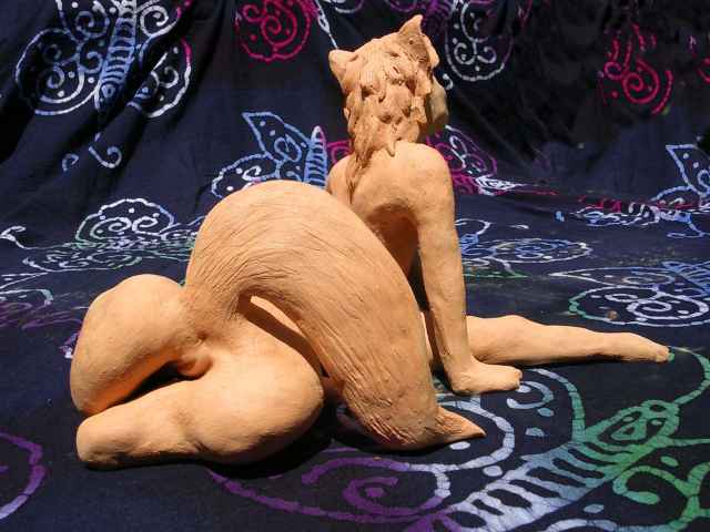 Vixentaur; a vulpine female centauroid reclining, half-curled, seen from back; unfired clay sculpture by Wayan. Click to enlarge.