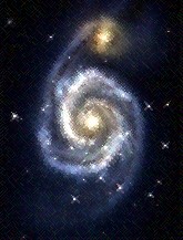 Photo of M51, a bluish spiral galaxy with golden core and a reddish satellite galaxy at the tip of the longest spiral arm.